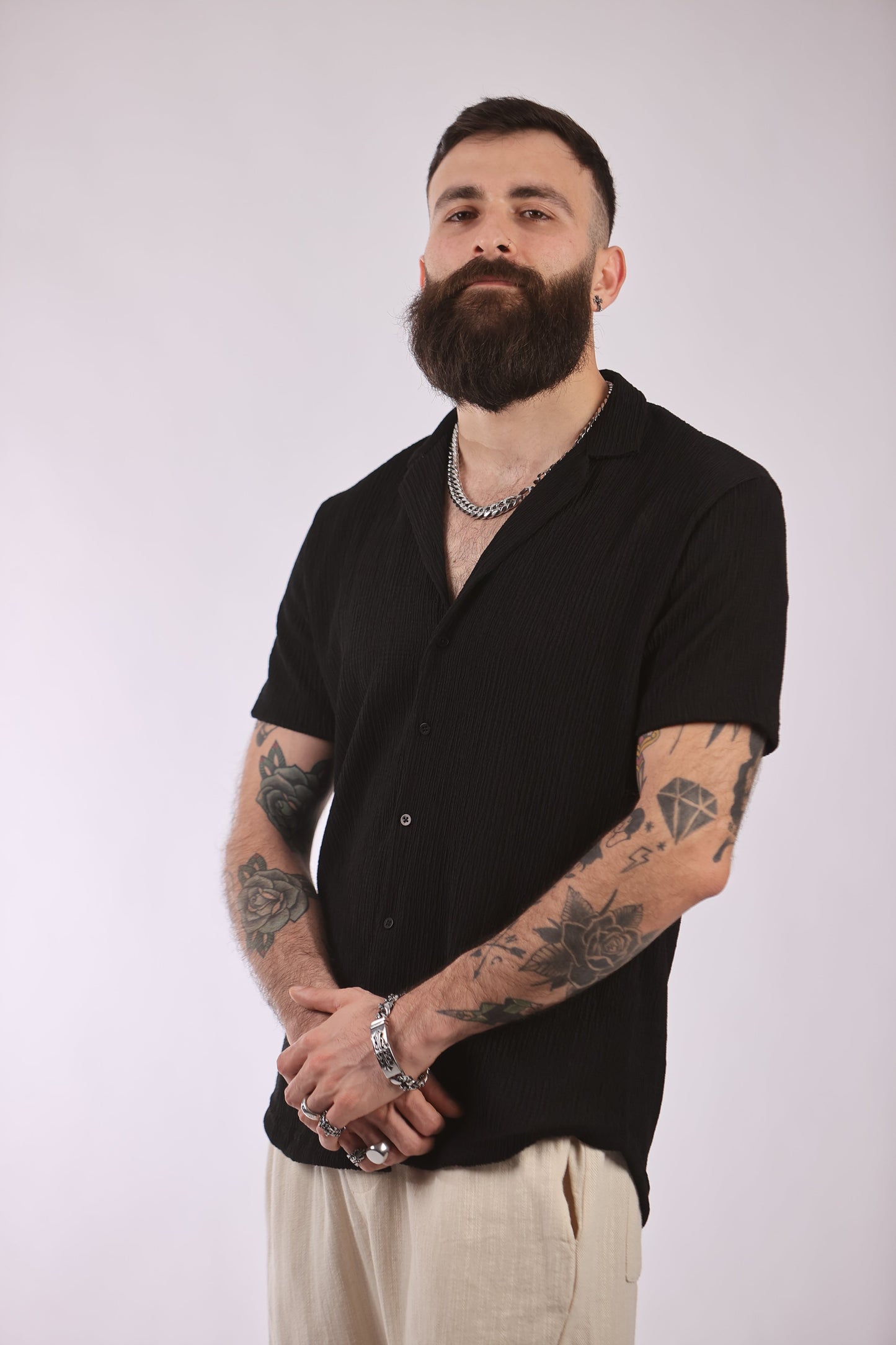 Polyester streetwear shirt in black, featuring short sleeves and a casual design, ideal for versatile fashion.