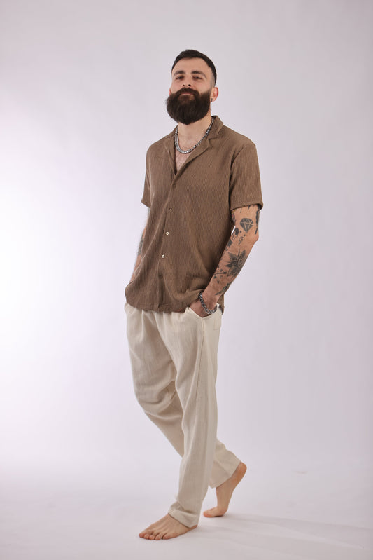 Marrakech pant in cream cotton, modeled with a brown shirt.