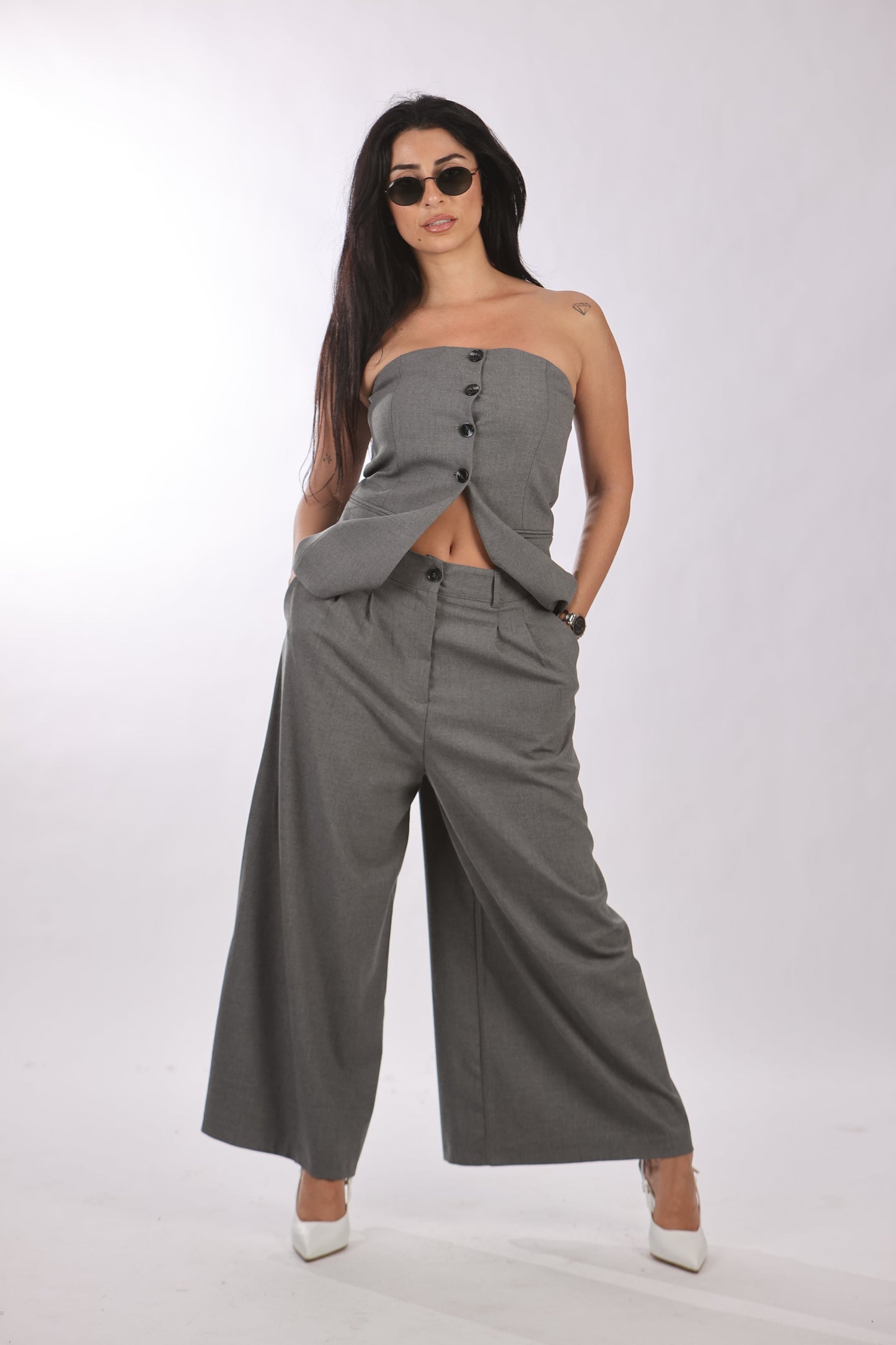 Quzu vest with buttoned-down front in gray, styled with matching wide-leg pants.