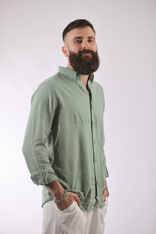 Unisex oversized streetwear shirt in light green linen-cotton blend, modeled with rolled sleeves.