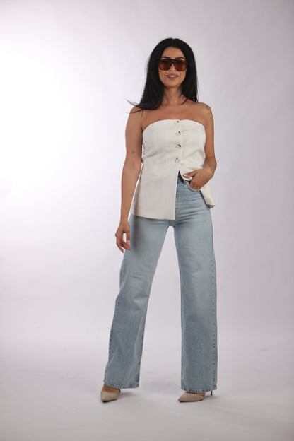 Basic straight jeans with classic washed look worn with white strapless top and sunglasses.